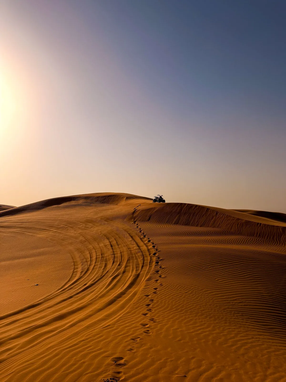 Soft curves of quiet desert dunes beneath an open sky